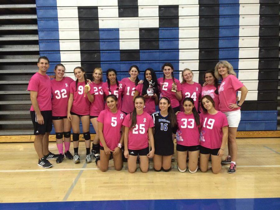 Solomon is standing in the top middle holding a silver trophy, Cohen is to her left holding a gold trophy at the Varsity Dig Pink Tournament.