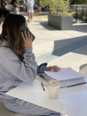 Noa Abromavitch ‘22 on the phone while doing homework

