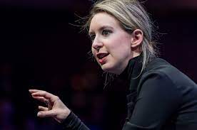 Elizabeth Holmes, seen here in her iconic black turtleneck and messy bun, talking about Theranos technology.