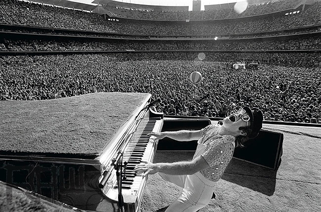 Elton John plays the piano at his famous 1975 concert at Dodger Stadium.