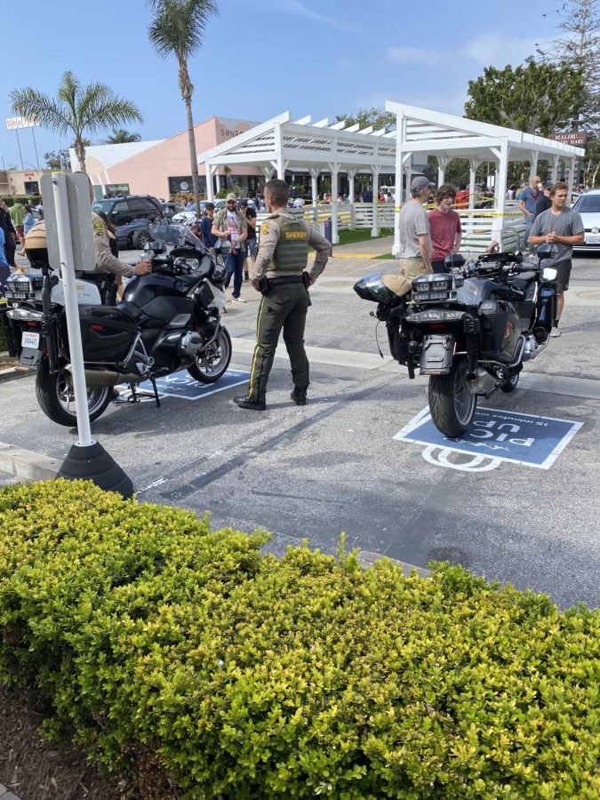 Two Sheriffs stand guard at the Malibu Country Mart, denying access to supercars.