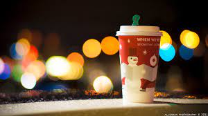 A Starbucks holiday drink  with the classic red cup and holiday design  