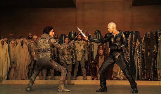 Paul Atreides (Timothee Chalamet) faces off in a knife battle against Feyd-Rautha (Austin Butler).
